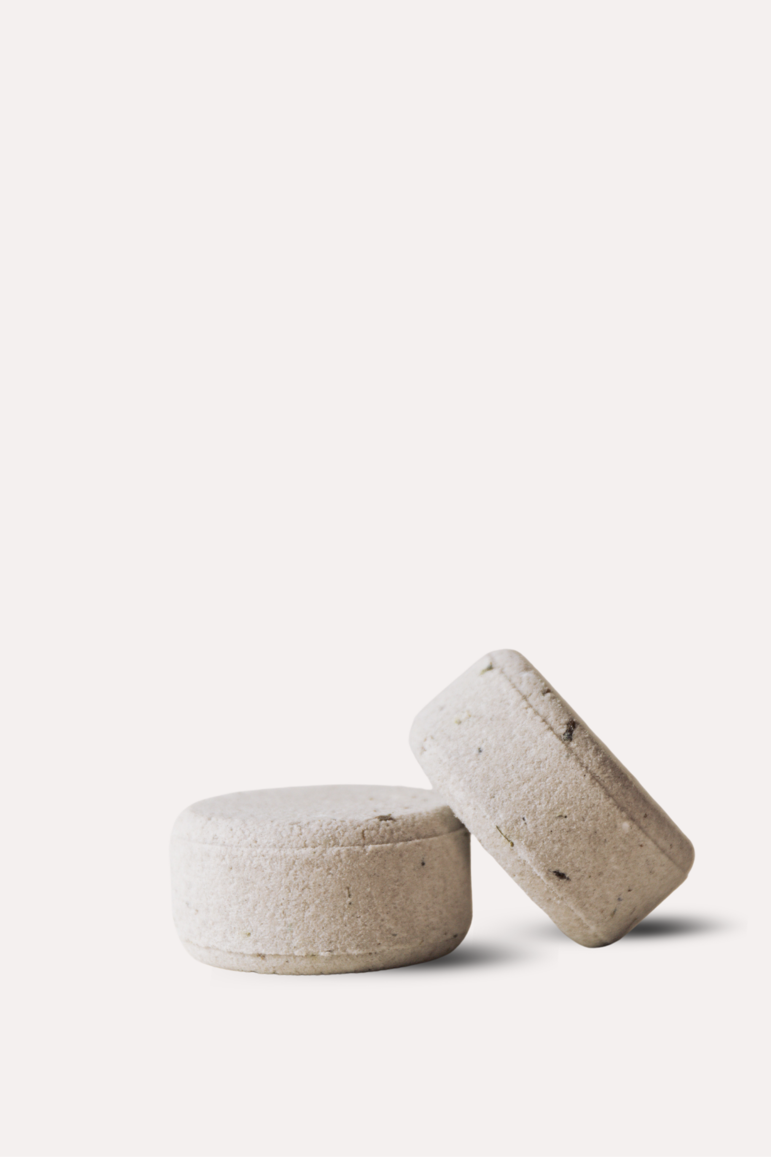 Two lavender bath bombs on a white background