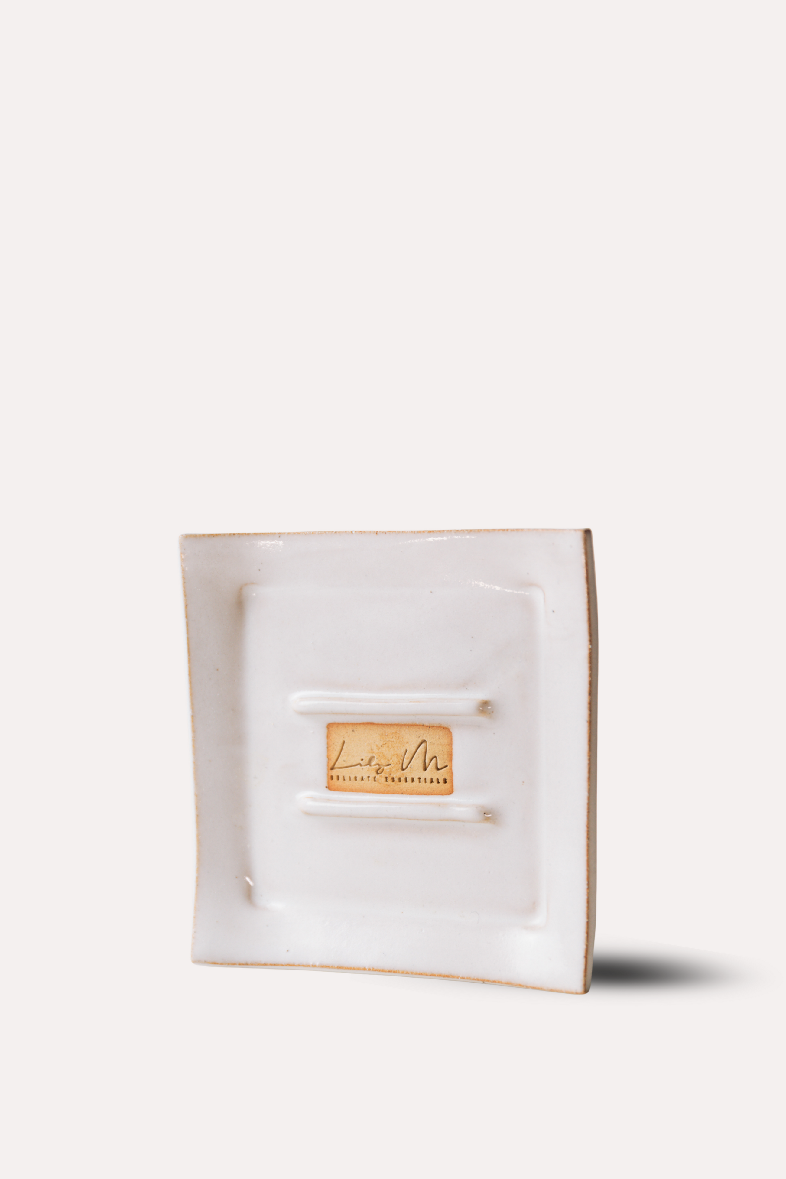 White jewelry box with a gold tag on a white background