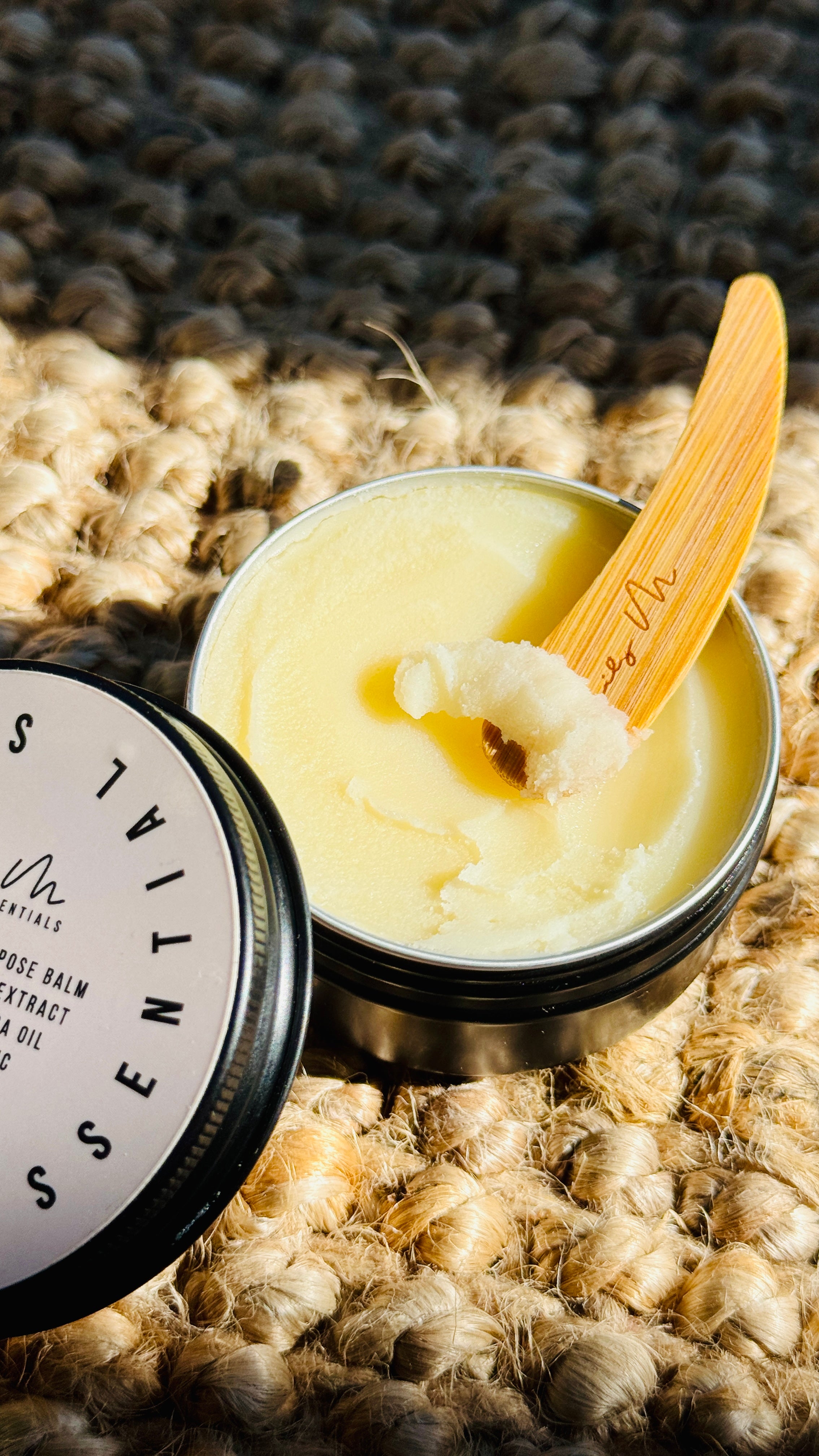 multi purpose balm with lid off and a wooden Lily M spatula, showing the texture - zoomed out image