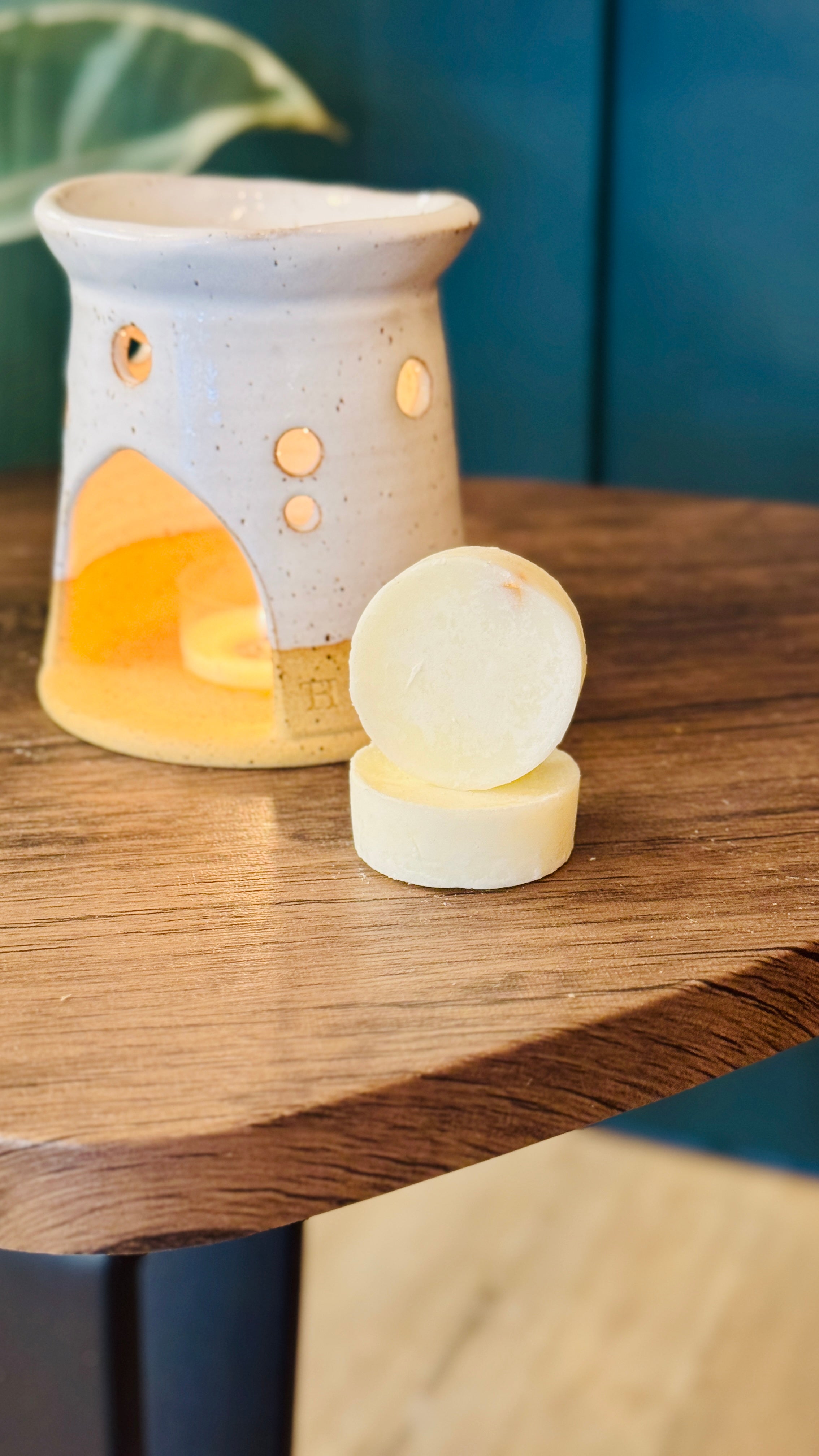 essential oil orange & lime wax melts with a wax melt burner in the background