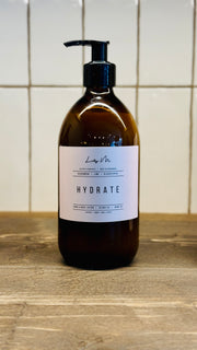 Cedarwood lime & Black pepper hand & Body lotion in a 500ml amber glass bottle with a black pump
