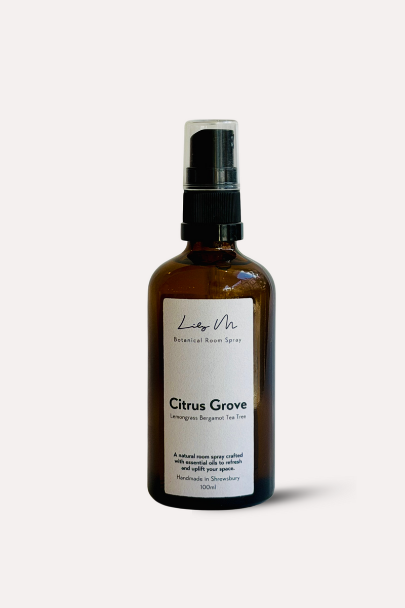 Brown spray bottle labeled 'Citrus Grove' on a white background