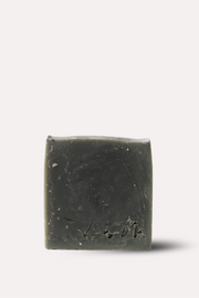 Bar of dark soap on a white background