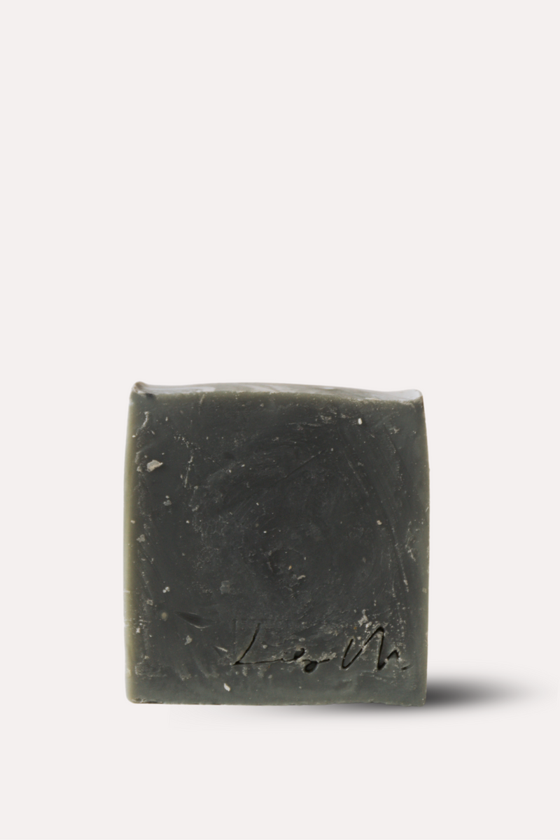 Bar of dark soap on a white background
