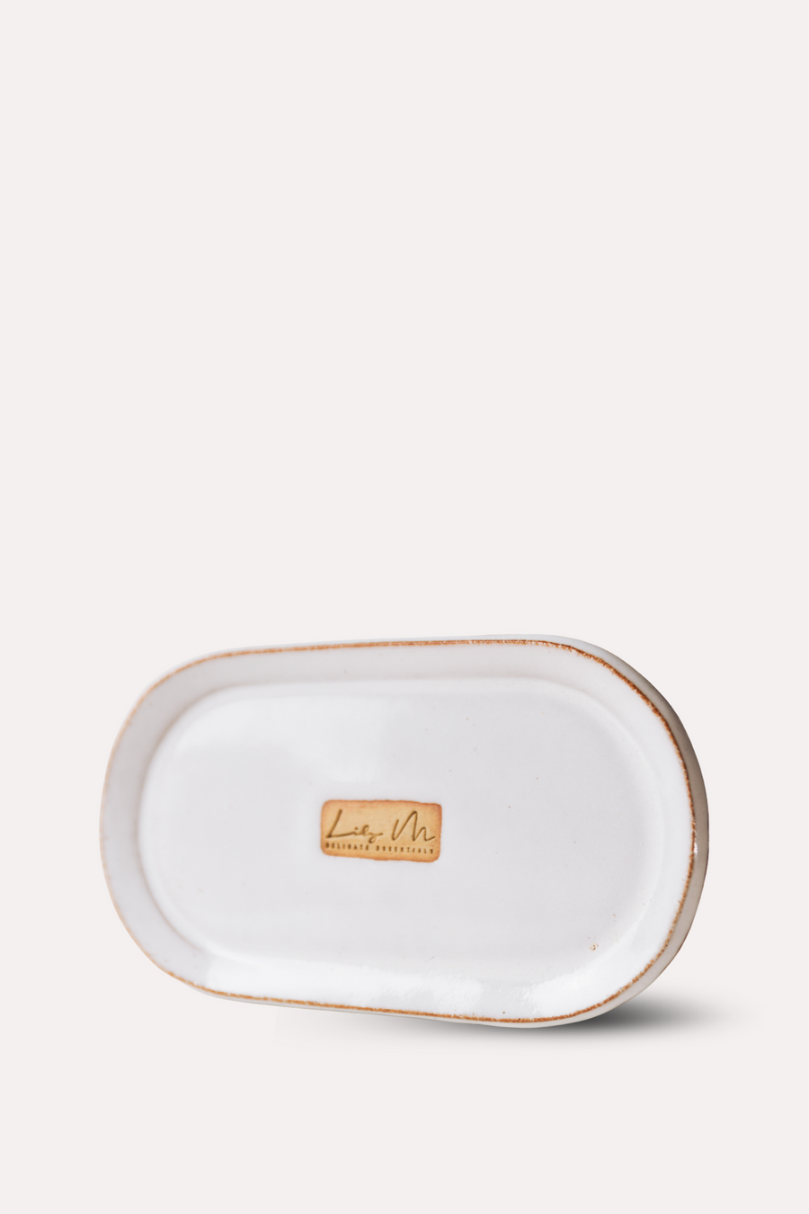 Rectangular ceramic tray with gold rim on a white background