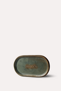 Small oval stone with a brand logo on a light gray background