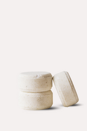 Three beige ceramic containers on a white background