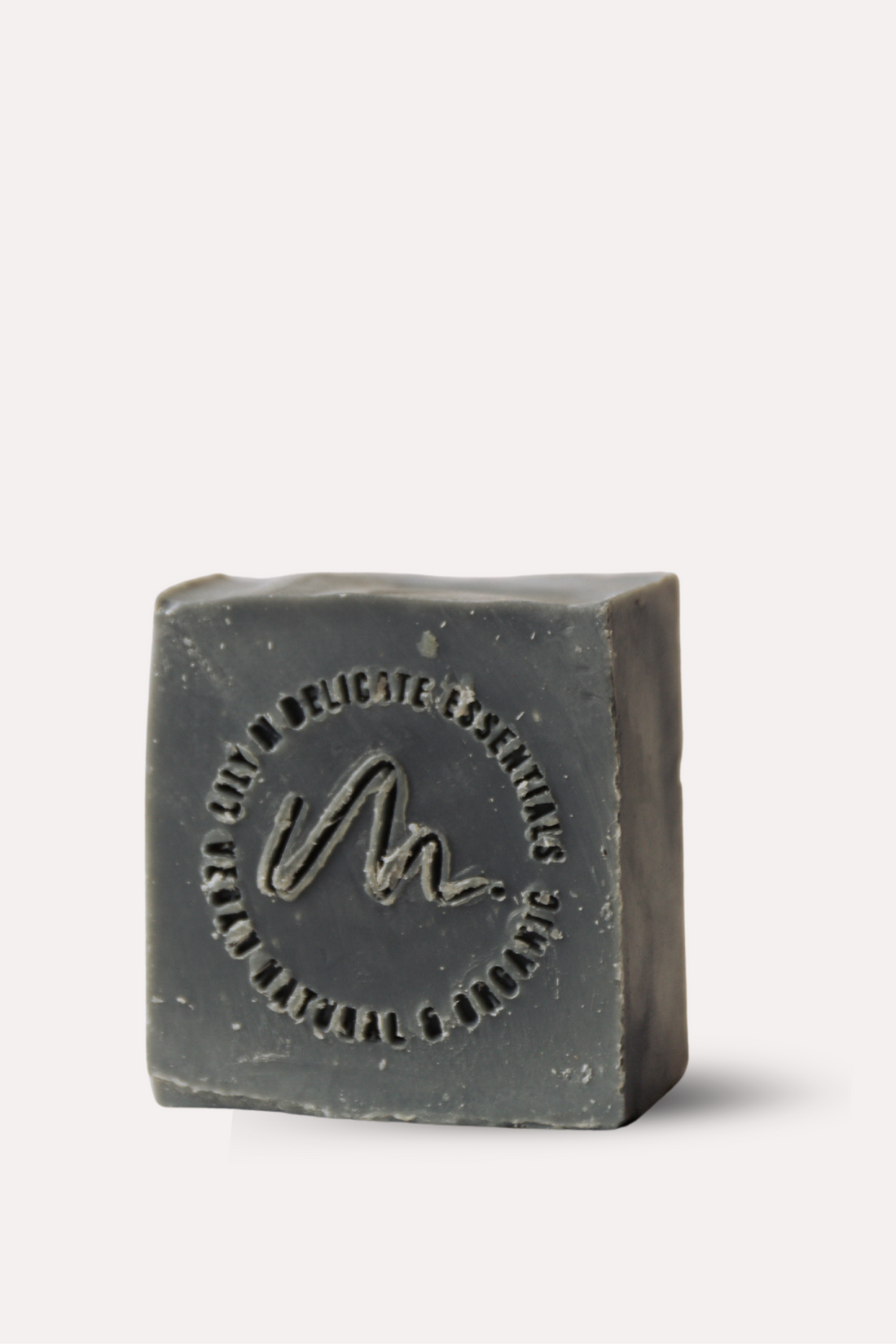 Bar of dark soap on a white background