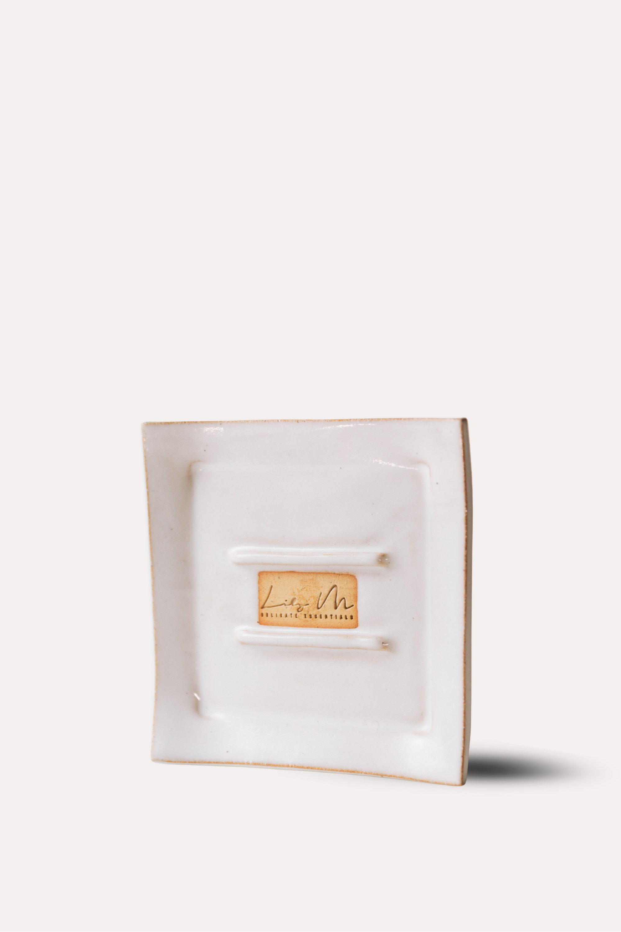 White jewelry box with a gold tag on a white background