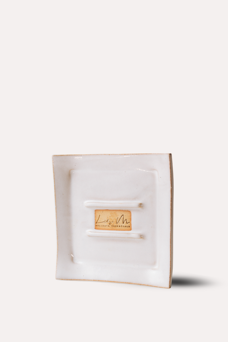 White jewelry box with a gold tag on a white background