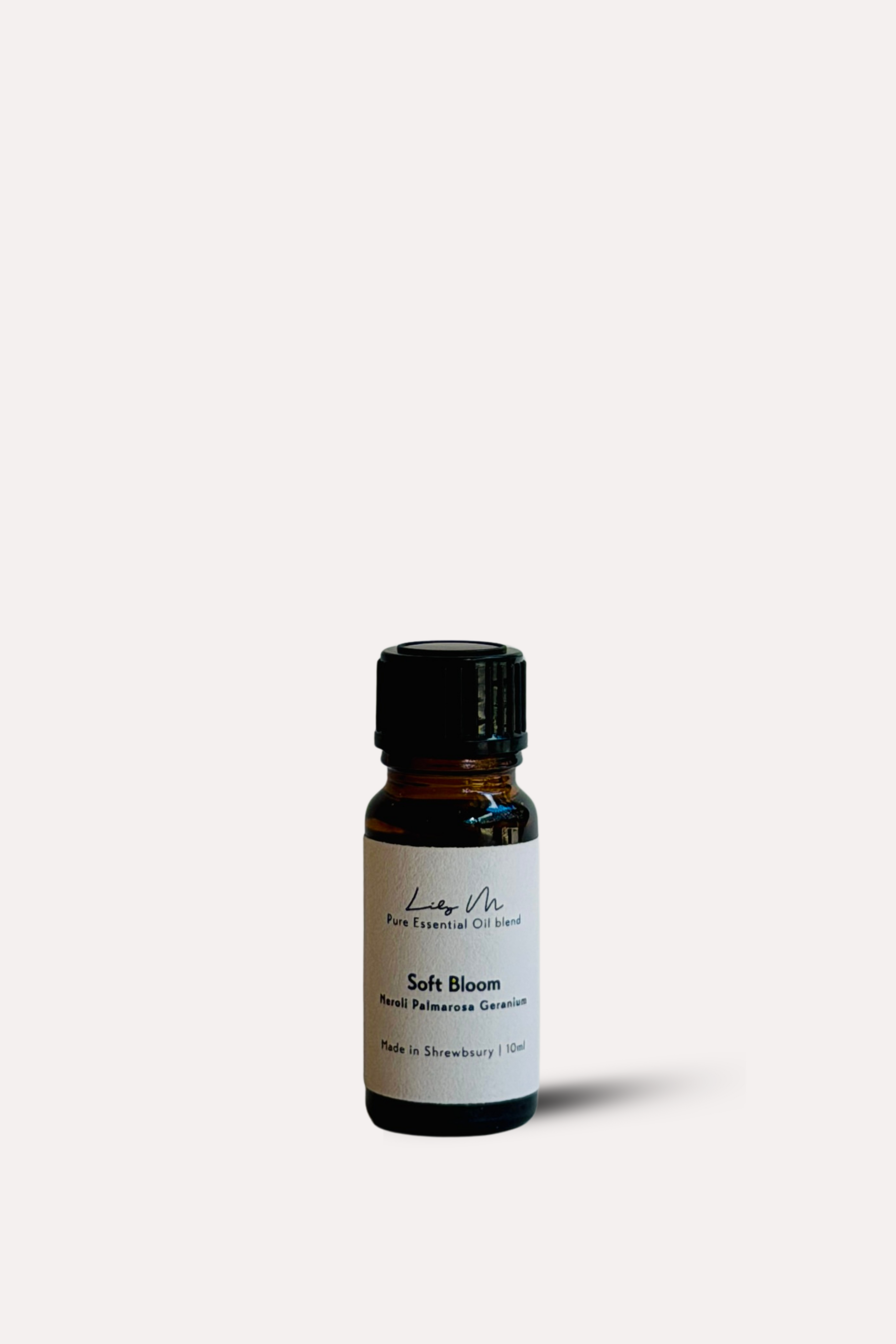 Small essential oil bottle labeled 'Soft Bloom' on a white background