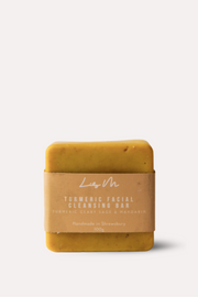 Yellow soap bar with a brown label on a white background