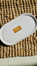 hand wash bottle tray on a hessian rug Lily M logo stamped in the the center of the tray unglazed, shows a brown rectangle around the logo