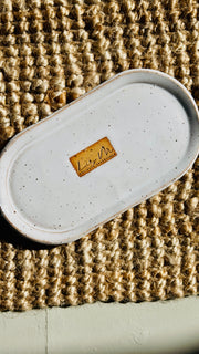 hand wash bottle tray on a hessian rug Lily M logo stamped in the the center of the tray unglazed, shows a brown rectangle around the logo