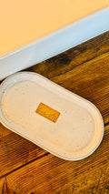 hand wash bottle tray on a wooden table  Lily M logo stamped in the center of the tray unglazed, shows a brown rectangle around the logo