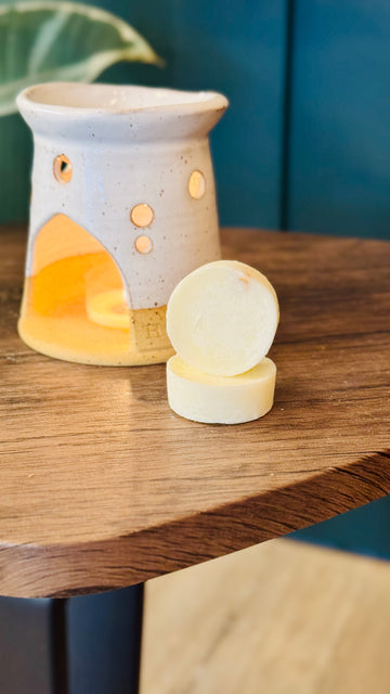 essential oil orange & lime wax melts with a wax melt burner in the background 